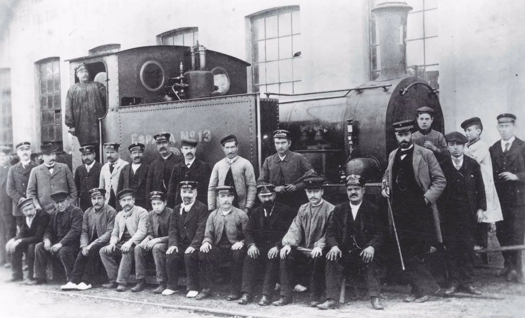 L’equip de maquinistes i fogoners de la companyia juntament amb els caps i els aprenents amb la locomotora de vapor número 13, que remolcava els vagons, l’any 1892