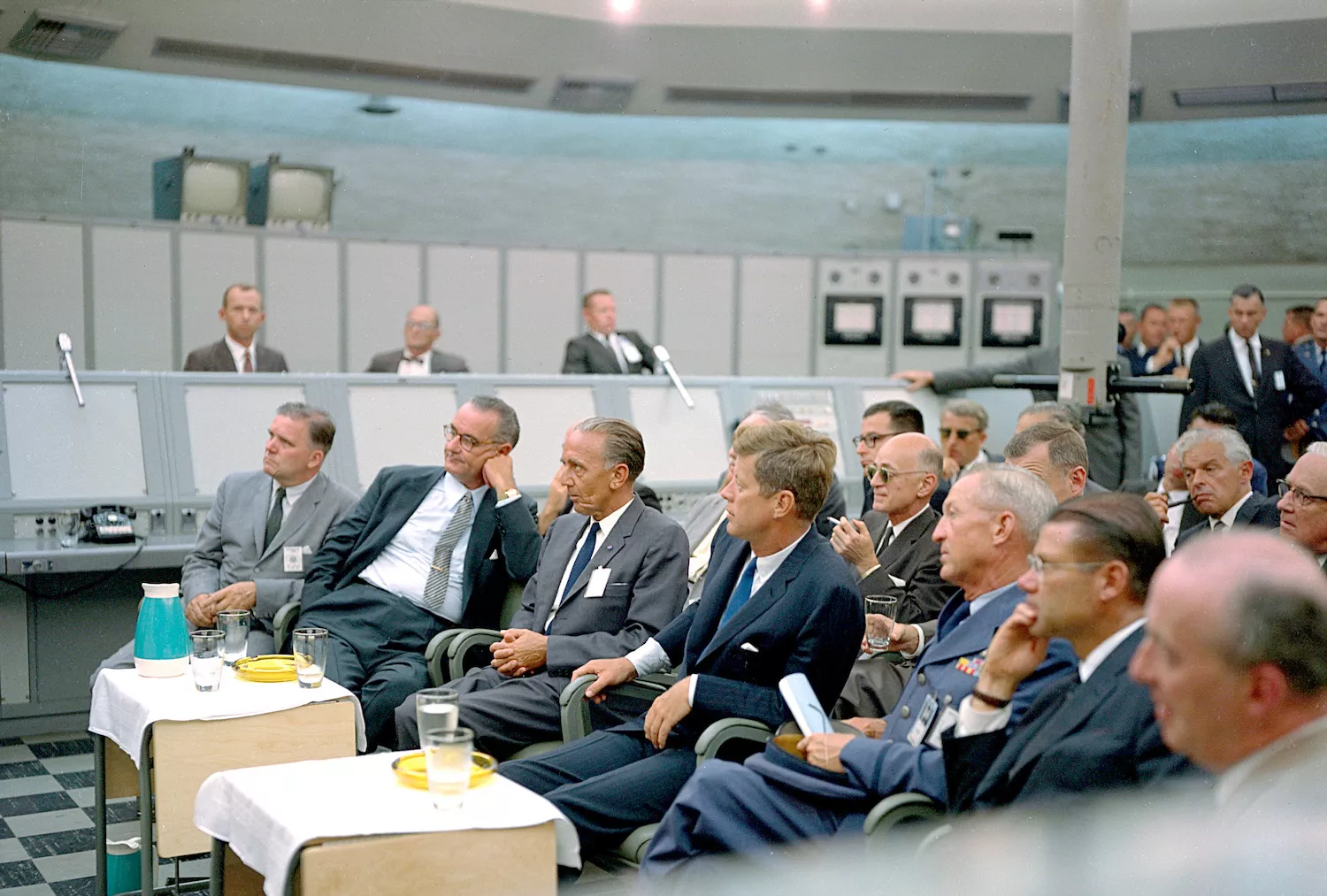Kurt H. Debus, director de la NASA, assegut entre el president John F. Kennedy i el vicepresident Lyndon B. Johnson, en una sessió informativa l'any 1962