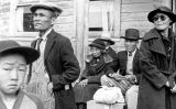 Famílies esperant l'autobús per anar a un dels centres de recol·locació de la WRA l'any 1942 Famílies esperant l'autobús per anar a un dels centres de recol·locació de la WRA l'any 1942